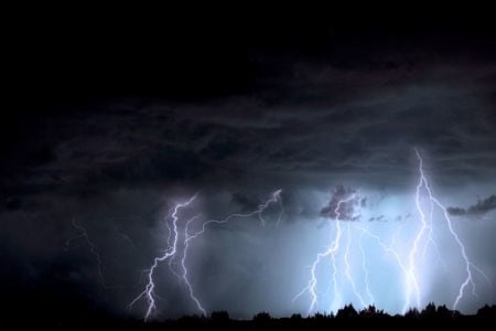 lightning in the background of a dark sky